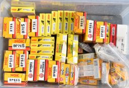 Approximately 150 NGK and Bosch spark plugs, all in original boxes