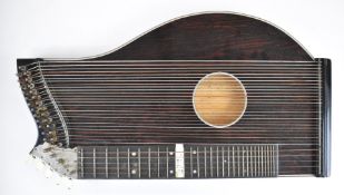 Thirty two string Austrian zither in fitted case, together with spare strings and tuning key.