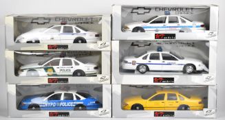 Six UT Models 1:18 scale diecast American police cars and a taxi, all in original boxes.