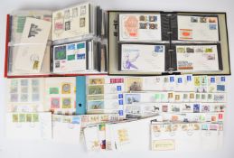 GB and world first day covers in two folders and loose, together with a blue stockbook containing