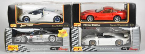 Four Maisto 1:18 scale diecast model sports cars comprising Ferrari 550 Maranello, Ford GT90,