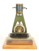 Vertical single cylinder live steam engine with solid flywheel, on wooden base, height 19cm