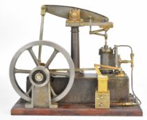 Stuart Beam live steam engine with eccentric type lubricator driving a spoked flywheel, on wooden