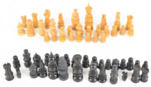 Fifty five boxwood and ebony chess pieces with ribbed columns or stacked discs.