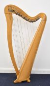 Thirty four string lever harp in beech wood with walnut inlay, height 128cm, with padded carry