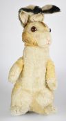 A large stuffed toy rabbit with golden mohair, disc jointed arms and neck, poseable ears, squeaker