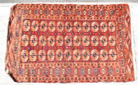 Turkoman rug with thirty three guls and geometric borders on a wine ground, 170 x 104cm