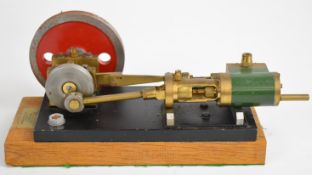 H.C.Crutchley, Suffolk, horizontal single cylinder live steam engine with disc flywheel, on wooden