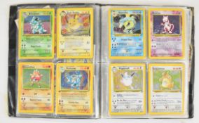 Pokémon folder containing approximately one hundred cards, Base, Fossil, Rocket etc, to include