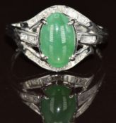 A 14k white gold ring set with a jadeite cabochon and diamonds, 3g, size N