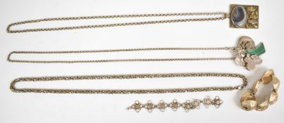 Two silver pendants, one set with malachite depicting a tree and the other owls set with agate,