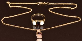 A 9ct gold charm and 9ct gold lamp (4.2g, 1.3cm, 45cm) and a 9ct gold ring set with a garnet and two