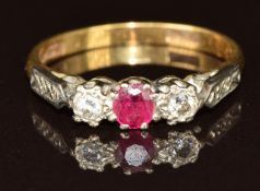An 18ct gold ring set with a round cut ruby and two diamonds, 2.9g, size L