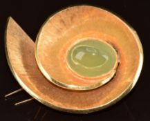 A yellow metal brooch in a spiral design set with a hardstone cabochon, 21.3g, 4 x 5cm
