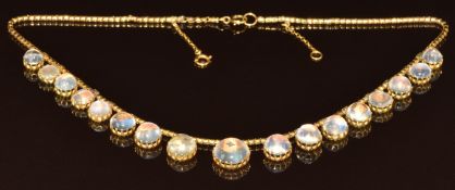 Victorian yellow metal necklace made up of a fancy link chain and seventeen round cut moonstone