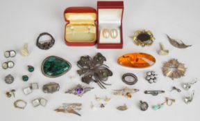 Eleven silver brooches including pressed amber, azurite, agate, etc, a Victorian mourning brooch and