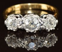 An 18ct gold ring set with three old cut diamonds measuring approximately 0.35, 0.2 & 0.2ct in a