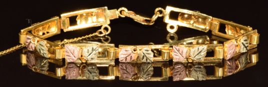 Black Hills 10k gold tri-coloured bracelet made up of rectangular links with foliate decoration,