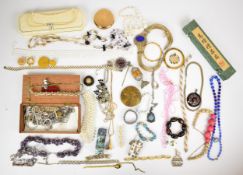 A collection of costume jewellery including beaded necklaces, Stratton compacts, amethyst