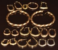 Seven pairs of 9ct gold hoop earrings including Greek Key, faceted, bi-coloured, etc and five single