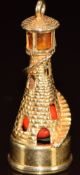 A 9ct gold charm in the form of a lighthouse which lights up using a battery in the base, 5.2g, 3.
