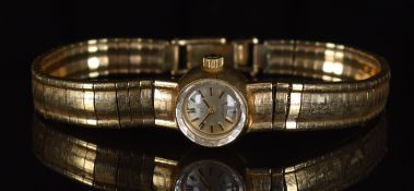 Omega 9ct gold ladies wristwatch with two-tone hands and baton hour markers, silver dial and