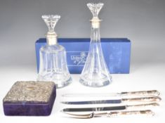 Hallmarked silver mounted items comprising two cut glass decanters with silver collars, velvet box