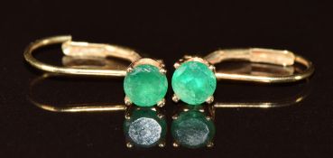 A pair of 14k gold earrings each set with a round cut emerald of approximately 0.3ct, 1.1g