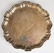 George VI hallmarked silver salver with shaped edge, raised on three feet, Birmingham 1937, maker