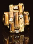 An 18k gold 1970's ring set with tiger's eye and diamonds, 10g, size O