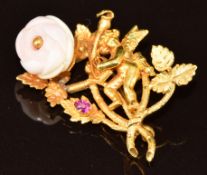 A c1880 Continental brooch in the form of Cupid set with a carved coral rose and a foiled pink