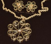 A 9ct gold pendant in a scrolling decoration (2.8cm) and matching earrings (1.4cm), 12.6g, 39cm
