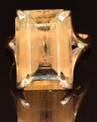 A yellow metal ring set with a smoky quartz, tests as 9k gold, 6.3g, size P