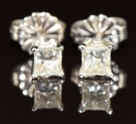 A pair of 14k white gold earrings each set with a princess cut diamond of approximately 0.2ct, 0.8g