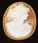 A 14k gold pendant / brooch set with a cameo depicting a young woman, 20.3g, 4.8 x 3.8cm