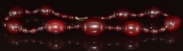 Cherry amber necklace made up of 35 oval beads, largest bead 2.2 x 2.8cm, smallest bead 1.7 x 2cm,