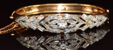 A yellow metal bangle (tests as 14k) set with paste in a white metal setting, 17g, 6.3 x 5.2cm