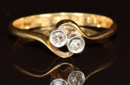 An 18ct gold ring set with two diamonds in a twist setting, 1.6g, size K