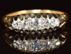 A c1900 18ct gold ring set with five diamonds, the centre diamond approximately 0.15ct, 3.2g, size N