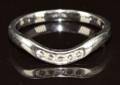 A platinum ring set with five diamonds, designed to fit around an engagement ring, 3.6g, size M