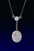 A c1915 necklace set with a large oval cut and smaller round cut opal cabochon, the first