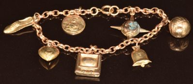 A 9ct gold charm bracelet with seven 9ct gold charms including heart, St Christopher, football, etc,