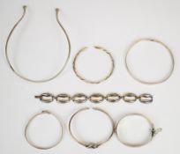 A collection of silver/ white metal jewellery including flapper bangle, knotted bangle, three