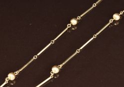 A 9ct gold necklace made up of elongated and textured sphere links,15.4g, 72cm