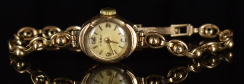 Victor 9ct gold ladies wristwatch with gold hands and hour markers, silver dial and signed 15