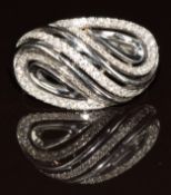 An 18k white gold ring set with diamonds in a stylised design, 4.8g, size N