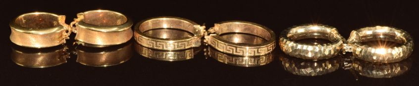 Three pairs of 9ct gold hoop earrings including one pair with Greek key decoration, 9.6g