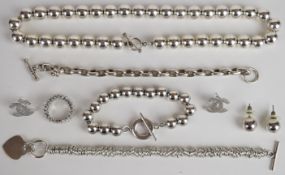 A collection of silver jewellery including necklace, earrings and matching bracelet made up of