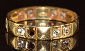 An 18ct gold eternity ring set with spinel, 3.2g, size N