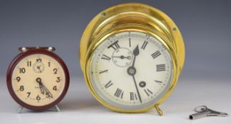 Swiza Bakelite alarm clock in original box and a brass ship's bulkhead type clock with subsidiary